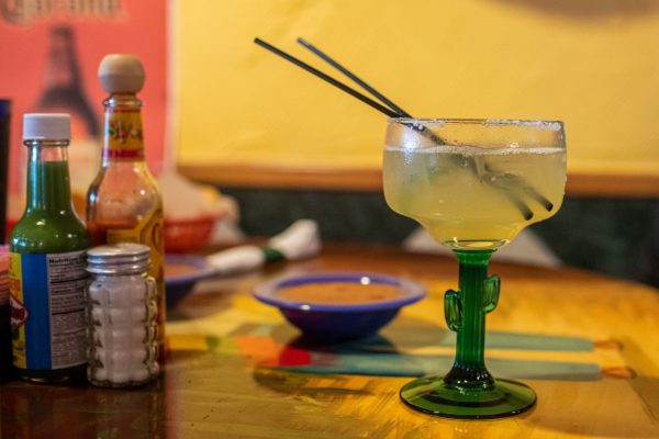 Margarita and salsa on table
